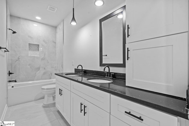 full bathroom with tile patterned floors, toilet, vanity, and tiled shower / bath