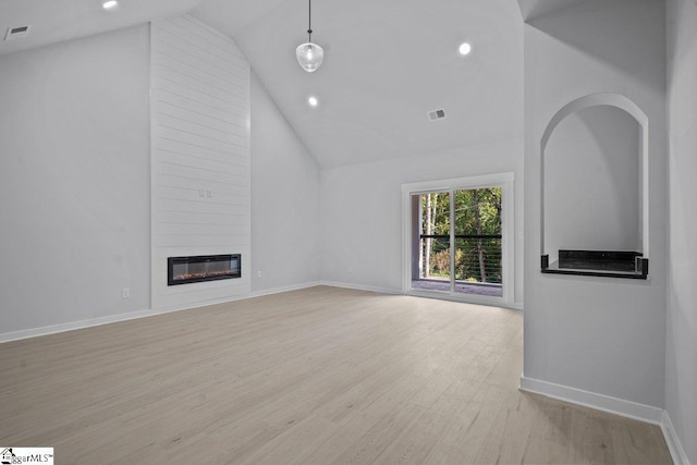 unfurnished living room featuring a fireplace, high vaulted ceiling, and light hardwood / wood-style flooring