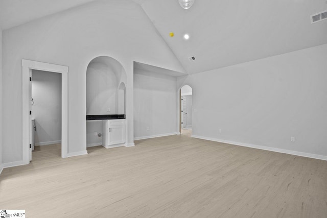 interior space with high vaulted ceiling and light wood-type flooring