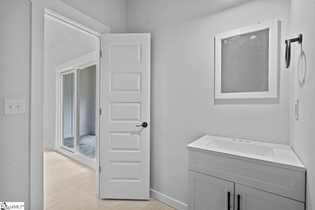 bathroom with hardwood / wood-style flooring and vanity