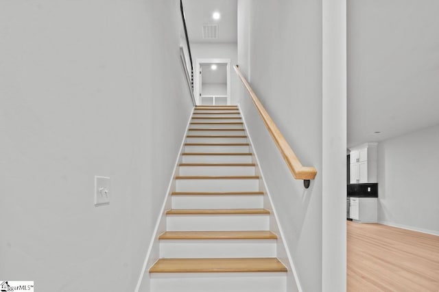 staircase featuring wood-type flooring