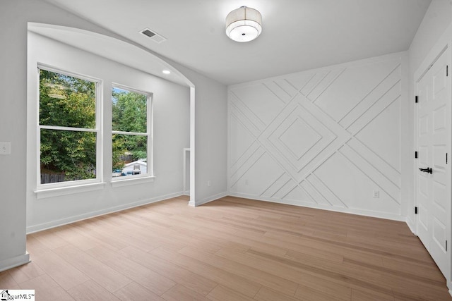 unfurnished room with light wood-type flooring