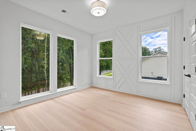 interior space featuring plenty of natural light and light hardwood / wood-style flooring