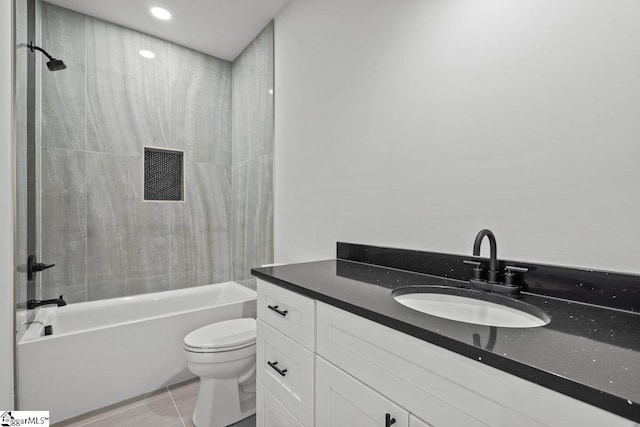 full bathroom featuring tile patterned floors, vanity, toilet, and tiled shower / bath