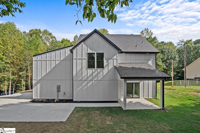 rear view of house featuring a patio area and a lawn