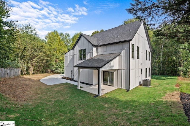 rear view of property featuring central air condition unit, a yard, and a patio