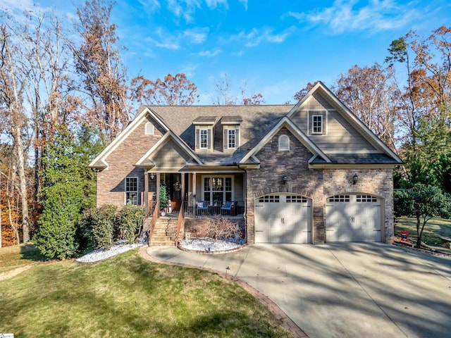 craftsman-style home featuring a porch, a garage, and a front lawn