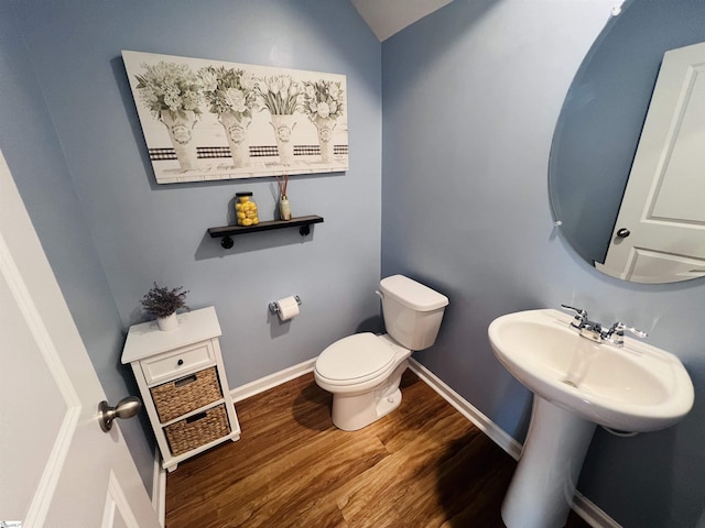 bathroom featuring wood-type flooring and toilet