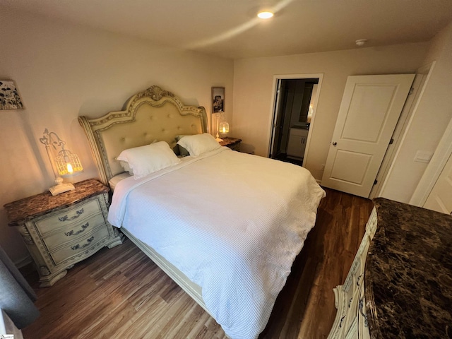 bedroom with dark hardwood / wood-style flooring