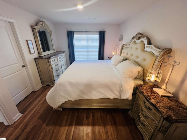 bedroom with dark wood-type flooring