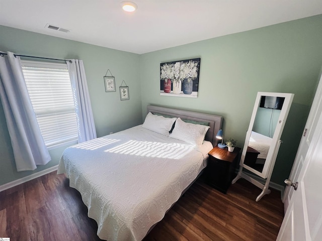 bedroom with dark hardwood / wood-style floors