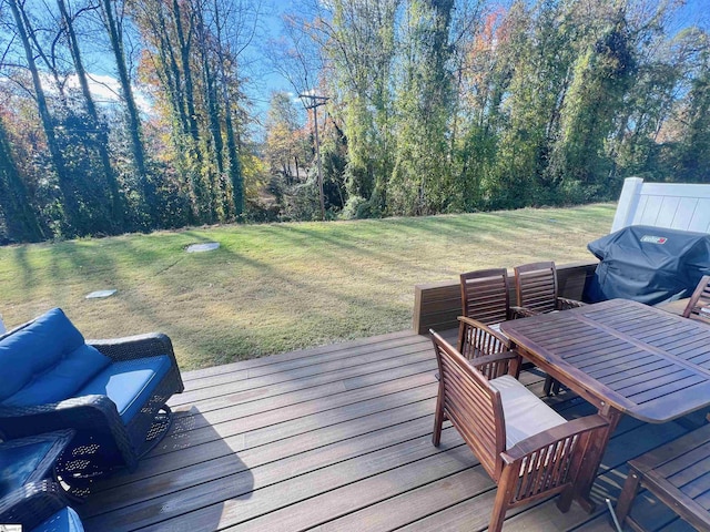 wooden deck with a yard and grilling area