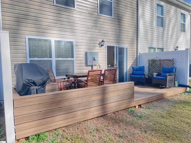 wooden terrace with outdoor lounge area and grilling area