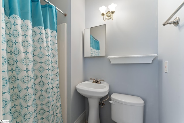 bathroom with a shower with curtain and toilet