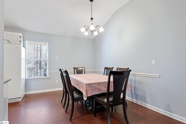 dining room with lofted ceiling, dark hardwood / wood-style floors, and a notable chandelier