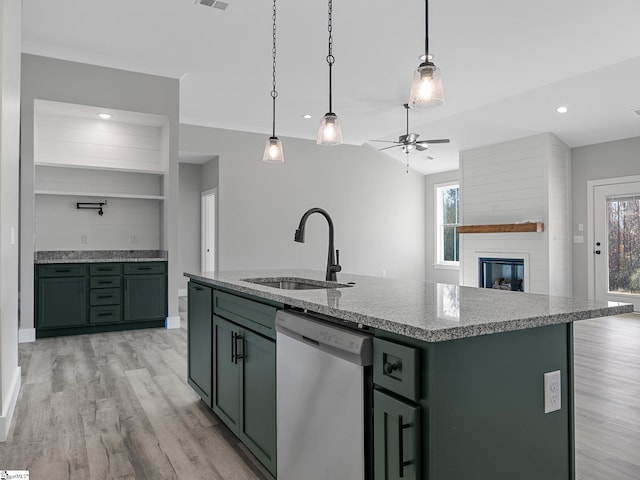 kitchen with stainless steel dishwasher, green cabinets, and a healthy amount of sunlight