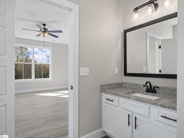 bathroom featuring hardwood / wood-style floors, vanity, and ceiling fan