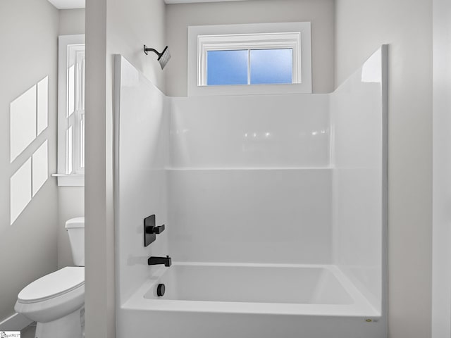 bathroom with shower / washtub combination and toilet