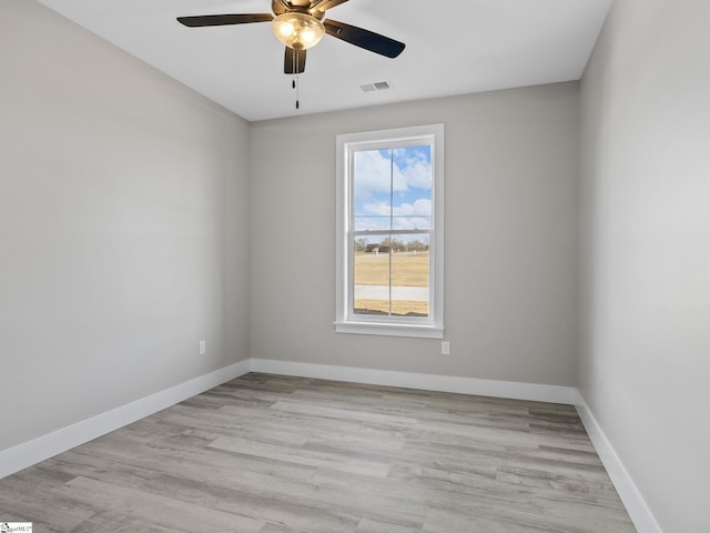 empty room with light wood-type flooring and ceiling fan