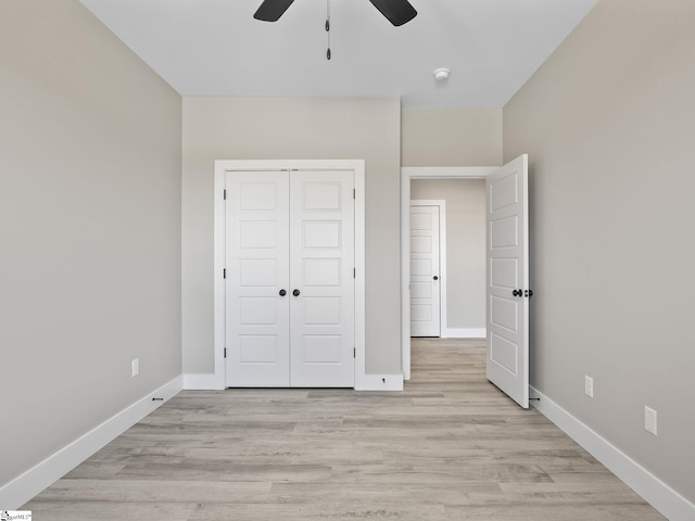 unfurnished bedroom with ceiling fan, a closet, and light hardwood / wood-style flooring