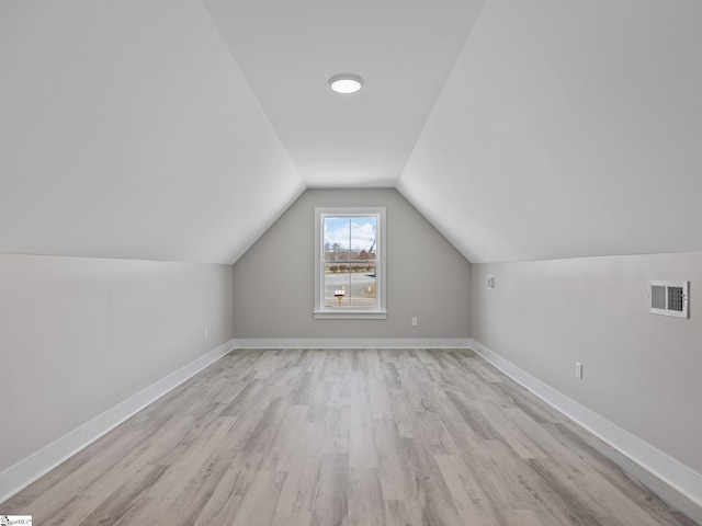 bonus room featuring light wood-type flooring and lofted ceiling