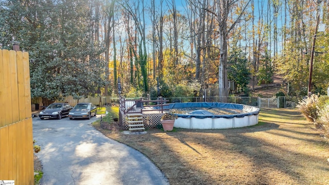 view of yard with a swimming pool side deck