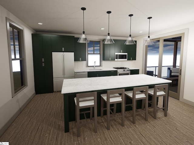 kitchen with pendant lighting, sink, backsplash, a center island, and premium appliances