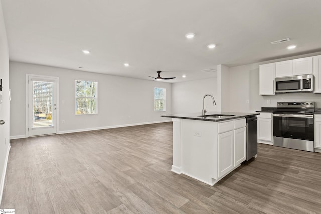 421 Haddon Trl Lot 58, Woodruff, SC 29388 - kitchen with stainless steel appliances, a sink, dark countertops, a ceiling fan, and wood finished floors