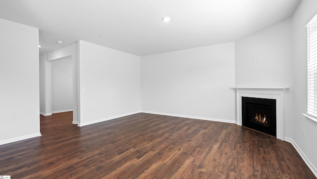 305 Lodestone Rd Lot 0267, Simpsonville, SC 29680 - unfurnished living room featuring baseboards, dark wood-style floors, recessed lighting, and a lit fireplace