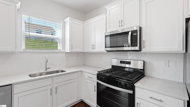 305 Lodestone Rd Lot 0267, Simpsonville, SC 29680 - kitchen with a sink, tasteful backsplash, white cabinetry, light countertops, and appliances with stainless steel finishes