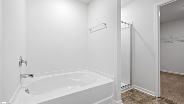 305 Lodestone Rd Lot 0267, Simpsonville, SC 29680 - bathroom with a shower stall, a spacious closet, stone finish floor, baseboards, and a garden tub