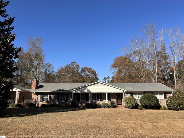 single story home featuring a front yard and covered porch