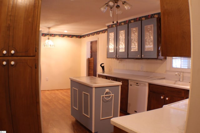 kitchen featuring sink, dishwasher, hanging light fixtures, a center island, and wood-type flooring