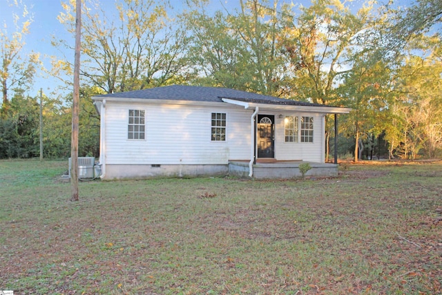 view of front facade with central air condition unit and a front yard