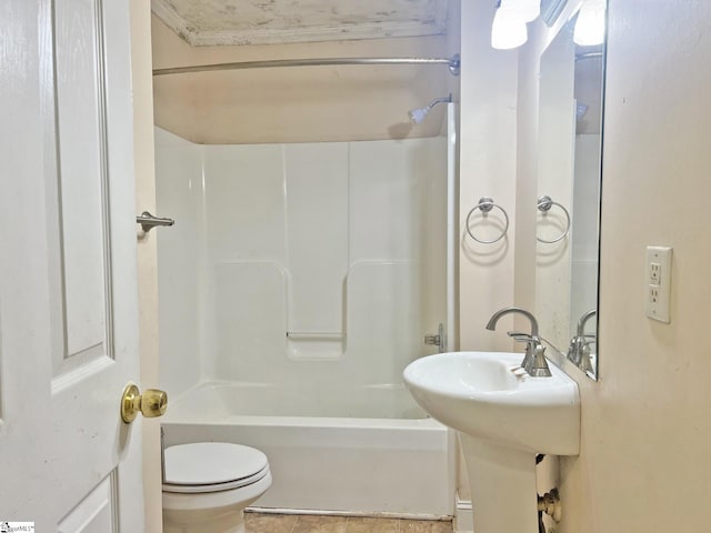 bathroom featuring tile patterned flooring, shower / bathing tub combination, and toilet