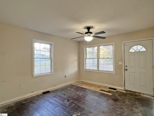 entryway featuring ceiling fan, dark hardwood / wood-style flooring, and a textured ceiling