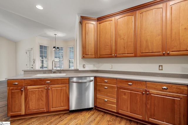 kitchen featuring light wood-type flooring, sink, pendant lighting, a notable chandelier, and dishwasher