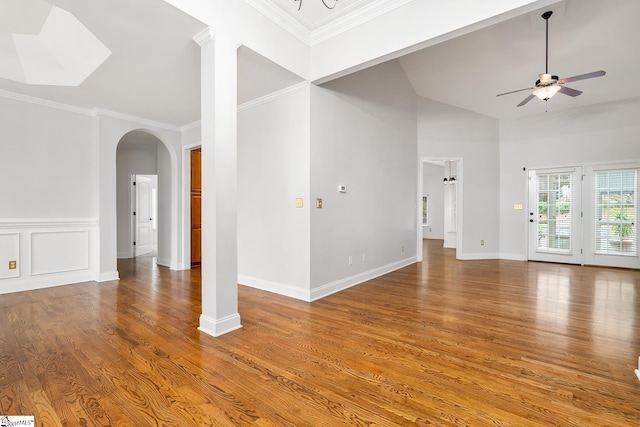 unfurnished living room featuring crown molding, ceiling fan, high vaulted ceiling, and hardwood / wood-style flooring