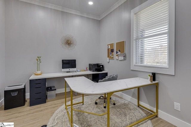 home office featuring crown molding and light hardwood / wood-style flooring