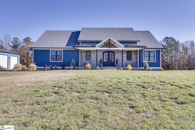 view of front facade with french doors and a front yard