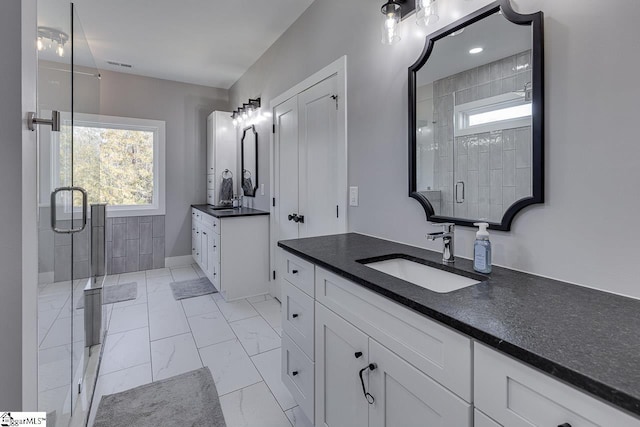 bathroom featuring vanity and an enclosed shower