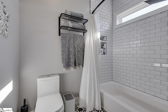 bathroom with shower / bath combo and toilet