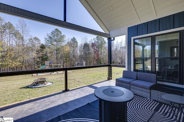 sunroom / solarium with a healthy amount of sunlight and vaulted ceiling