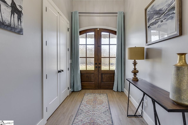 entryway featuring french doors and light hardwood / wood-style floors