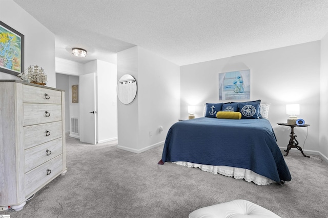 carpeted bedroom with a textured ceiling