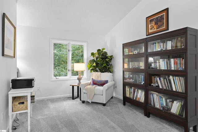 sitting room featuring light carpet and vaulted ceiling