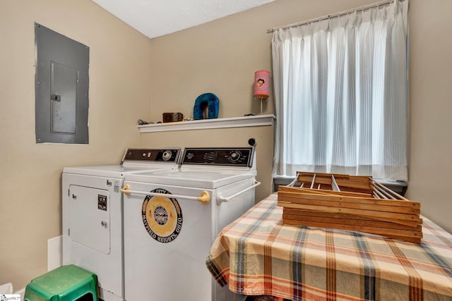 laundry room featuring electric panel and washer and clothes dryer