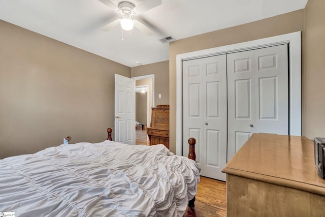 bedroom with ceiling fan, a closet, and light hardwood / wood-style flooring