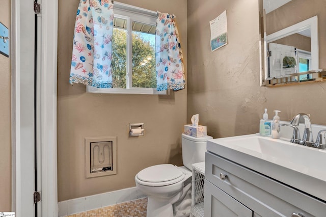 bathroom with tile patterned floors, vanity, and toilet