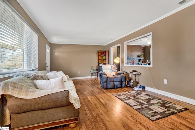 living room with hardwood / wood-style flooring and crown molding